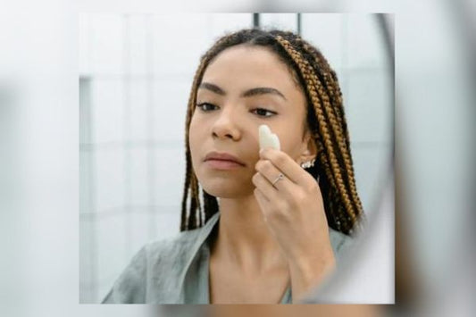 Woman using Gua-Sha on face