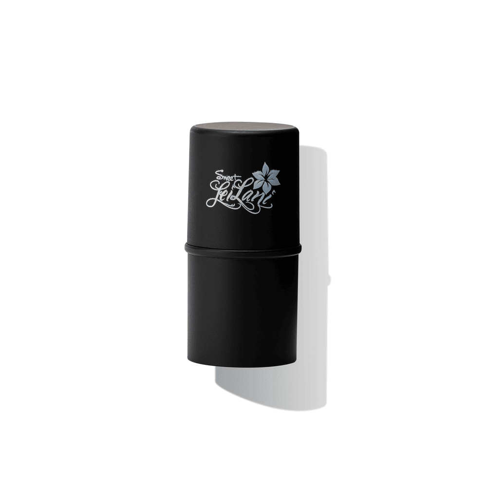 A black multi-functional creme stick with the text 'Island Tides' and a floral logo on the cap.