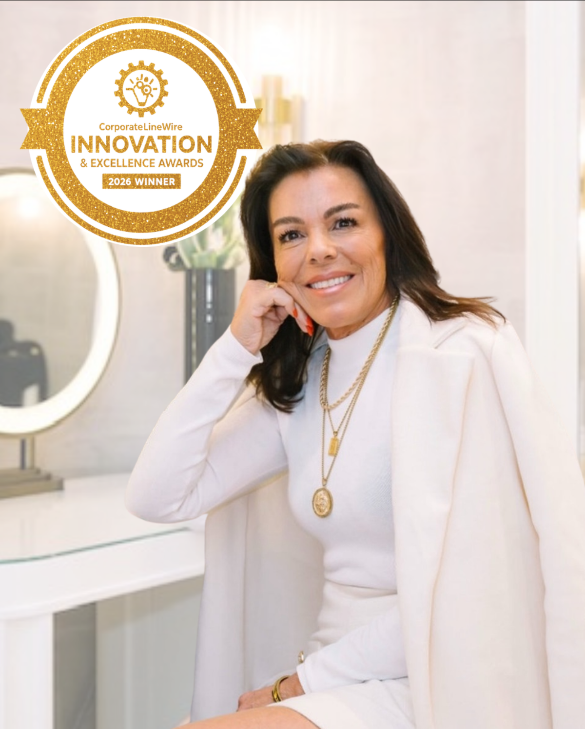 LeiLani Kopp, founder of Sweet LeiLani Cosmetics, at her desk beneath the brand logo.