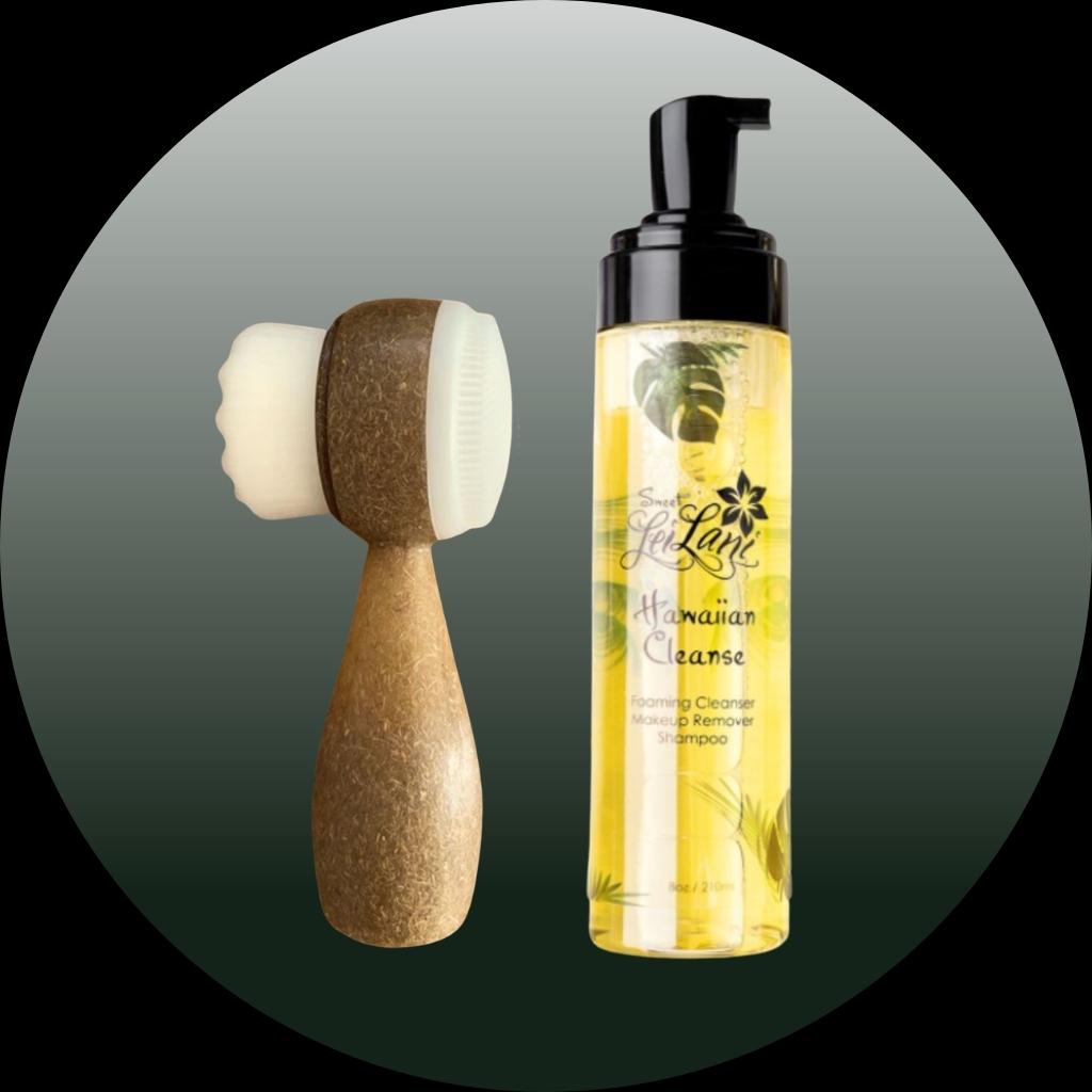 An image featuring a yellow pump bottle labeled 'Hawaiian Foaming Cleanser and Shampoo' next to a two-sided facial brush with soft bristles on one side and a rougher exfoliating surface on the other.