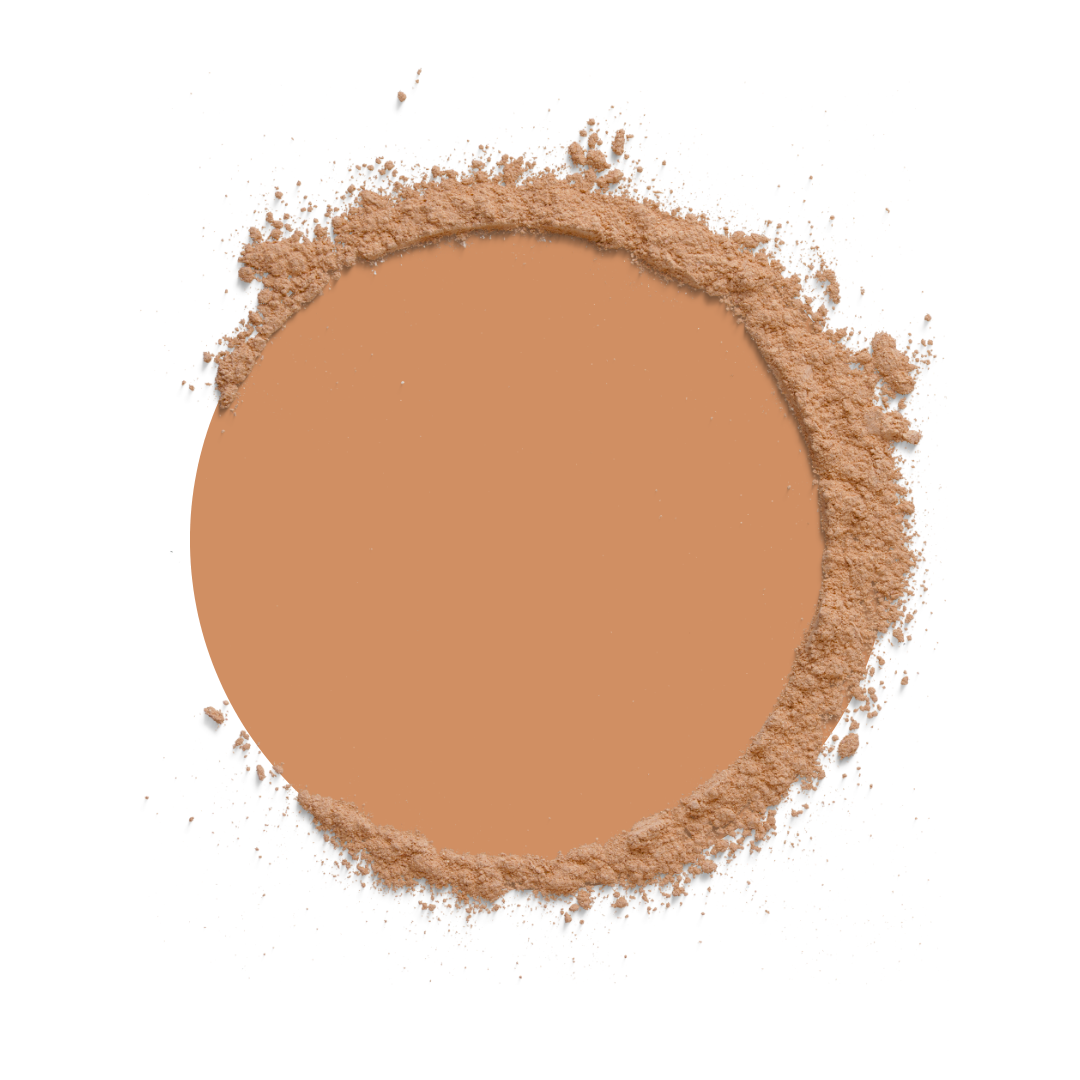 Circular compact of brown powder on a white background